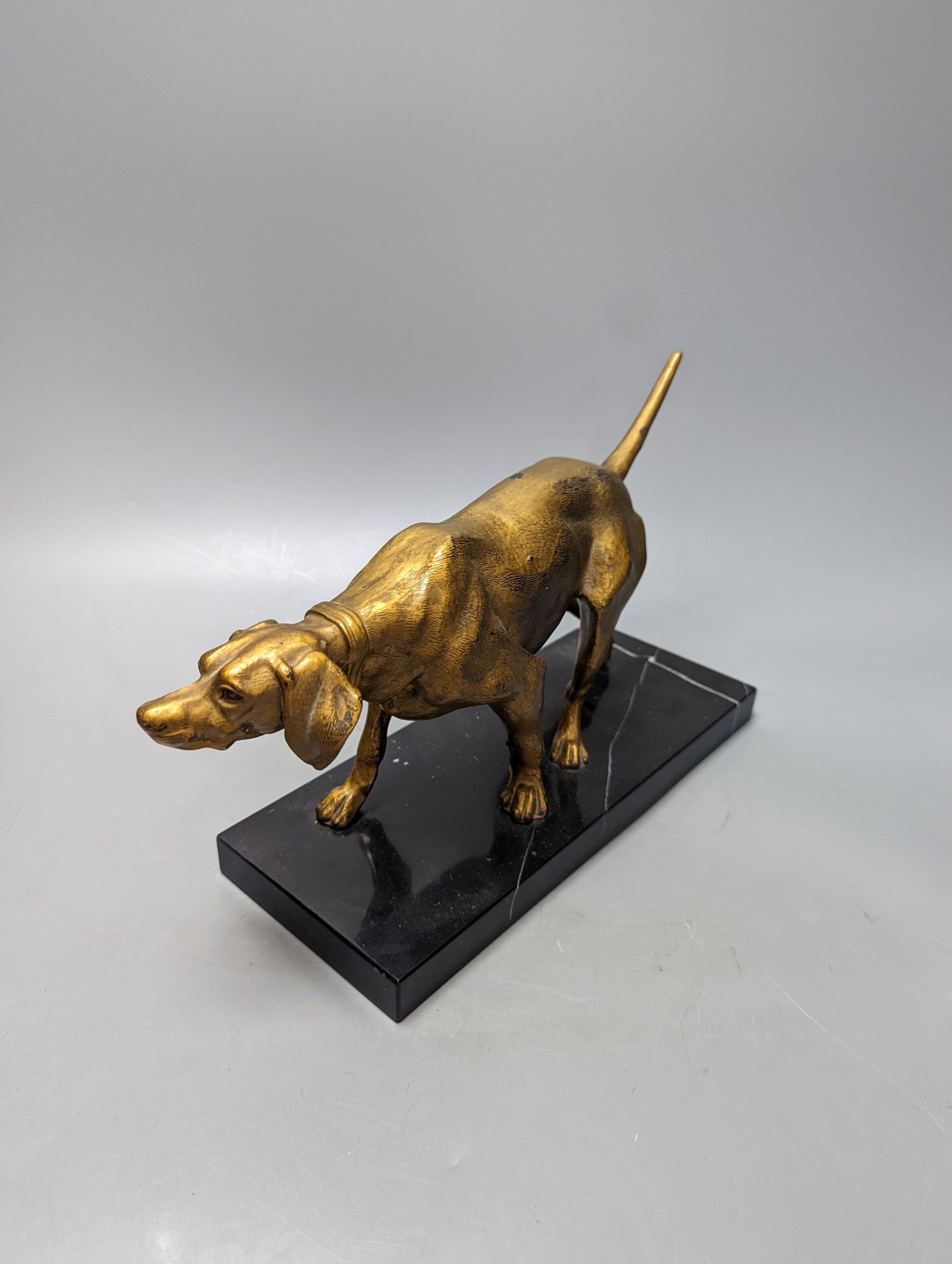 A gilt-metal model of a pointer on marble base 29cm